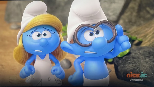 Smurfette and Brainy look slightly worried about what Scaredy Smurf is doing.
